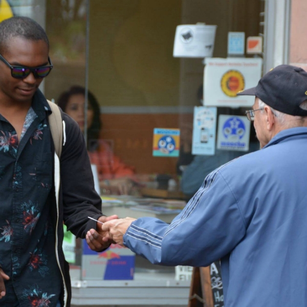 LARRY PASSES OUT TRACTS IN BERKELEY.